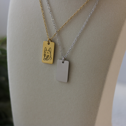 Two necklaces with rectangular pendants on a mannequin bust.