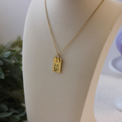 Gold necklace with a pendant on a mannequin bust