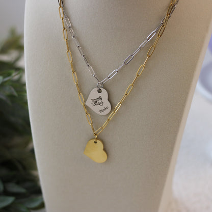 Two necklaces with heart-shaped pendants on a mannequin bust.