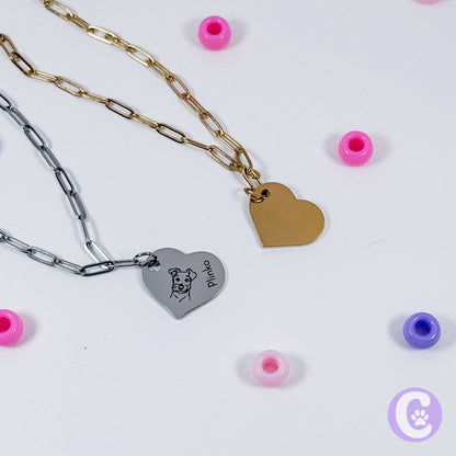Two heart-shaped pendant necklaces on a white background with small colorful beads around.