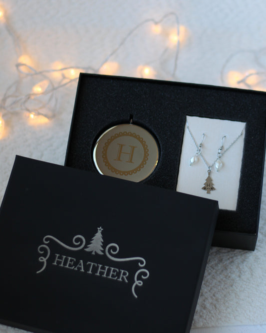 Jewelry set with pendant and necklace in a black box labeled 'Heather' on a soft background.