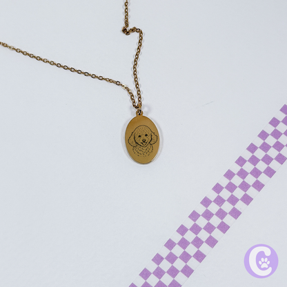 Gold necklace with pet line art pendant on a light purple background