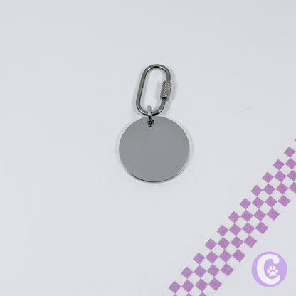 Silver keychain with a round tag on a light gray background